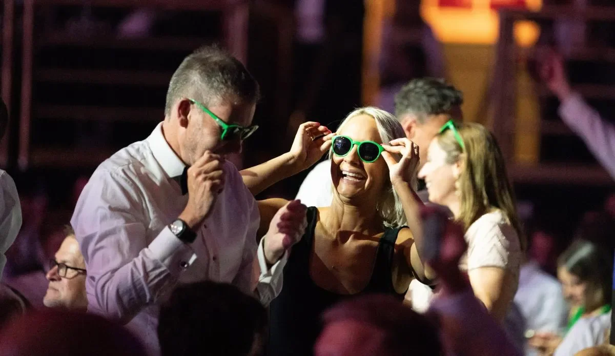 Attendees dancing with sunglasses